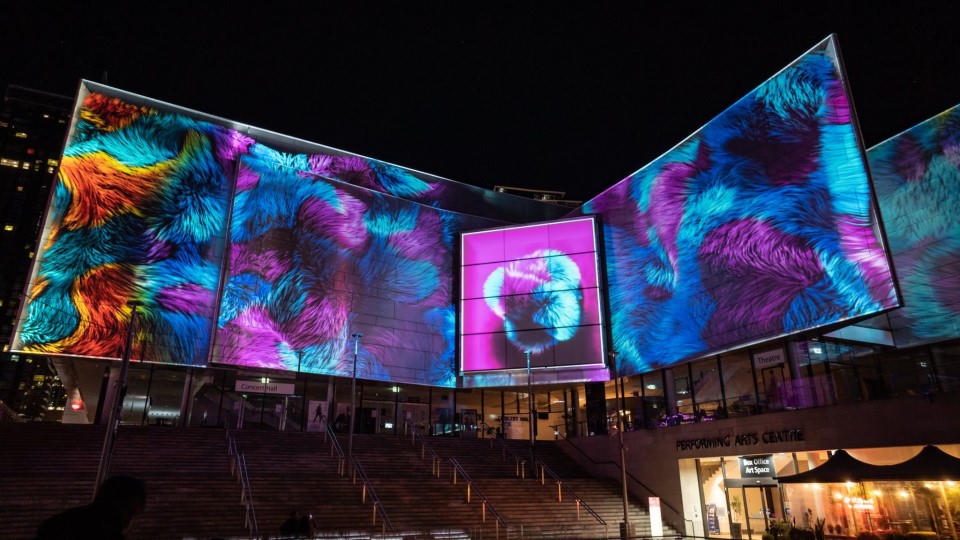 Building facade with colourful projection mapping