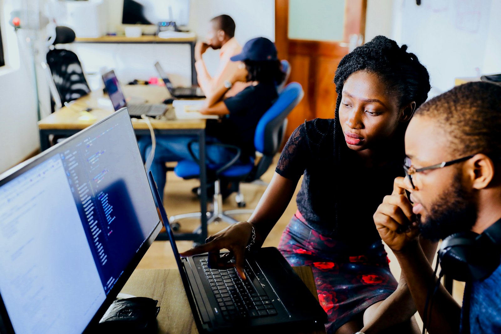 People collaborating around laptops